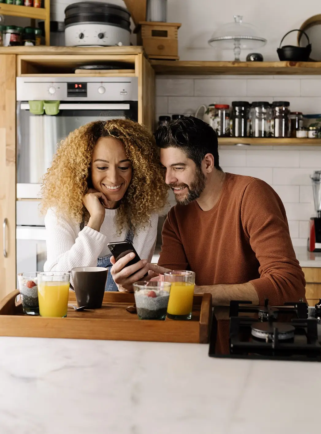 A woman is using a tap to pay function on her phone tied to her Simply Free Checking Account